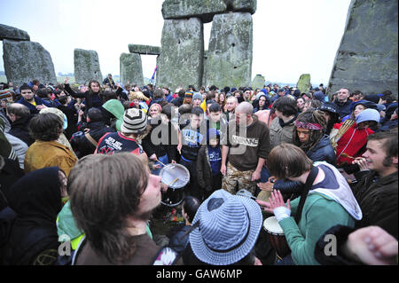 Les fêtards se régalent en début de matinée, car le mauvais temps et la pluie empêchent le soleil de briller le matin du solstice d'été à Stonehenge, Wiltshire. Banque D'Images