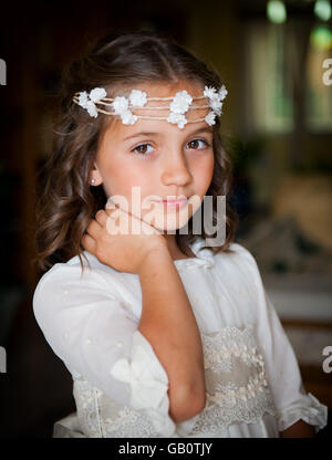 Belle petite fille sur la tête une couronne de petites fleurs Banque D'Images