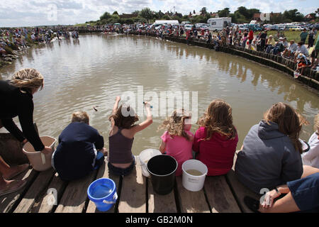 Concurrent participant aux championnats annuels de pêche au crabe britannique à Walberswick, Suffolk. Banque D'Images