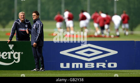 Fabio Capello, responsable de l'Angleterre, et Sir Trevor Brooking, Directeur du développement du football pour la FA, parlent pendant la séance d'entraînement en Angleterre. Banque D'Images