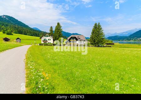 Le long de la Route verte prairie alpine typique avec des maisons de distance en paysage estival du lac Weissensee, Autriche Banque D'Images