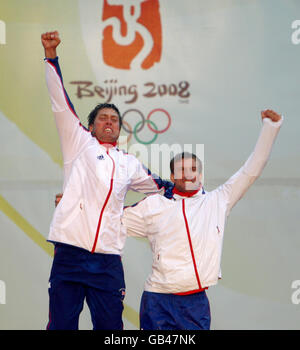 Andrew Simpson (à gauche) et Iain Percy, membres de l'équipe Star de Grande-Bretagne, célèbrent sur le podium après avoir remporté leur cours au centre de voile des Jeux Olympiques de Beijing 2008 à Qingdao, en Chine. Banque D'Images