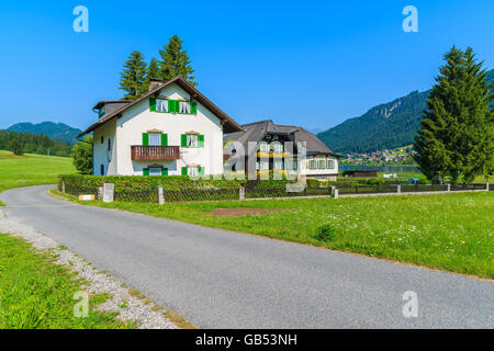 Maisons typiques le long de la route de campagne de montagnes des Alpes en été paysage de lac Weissensee, Autriche Banque D'Images