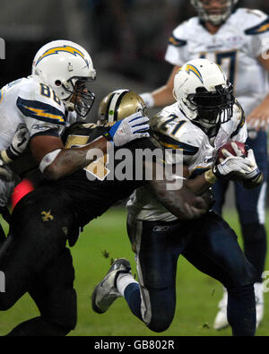 San Diego Chargers en cours de retour LaDainian Tomlinson est descendu par le linebacker Jonathan Vilma de la New Orleans Saints lors du match de la NFL au Wembley Stadium, Londres. Banque D'Images