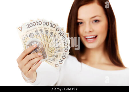 Happy young lady holding cash-Polish zloty Banque D'Images