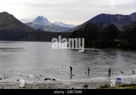 Derwentwater près de Keswick solide gelé avec un panneau d'avertissement de police glace aujourd'hui que le sort de froid continue. Banque D'Images