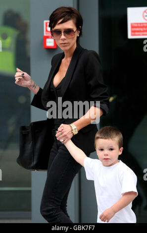 Victoria Beckham arrive de Milan au terminal 5 de l'aéroport de Heathrow, Middlesex, avec son fils Cruz. Banque D'Images