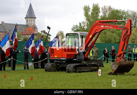 Une pelle réalise la première coupe d'un site de sépulture de masse de la première Guerre mondiale à Pheasant Wood, Fromelles, dans le nord de la France, lors de l'inauguration et de la cérémonie de bénédiction. Banque D'Images