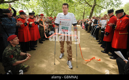 Le Major Phil Packer, 36 ans, qui a perdu l'usage de ses jambes lors d'une attaque à Basra en février dernier arrive au Mall, Londres pour terminer le Marathon Flora London deux semaines après son départ. Banque D'Images