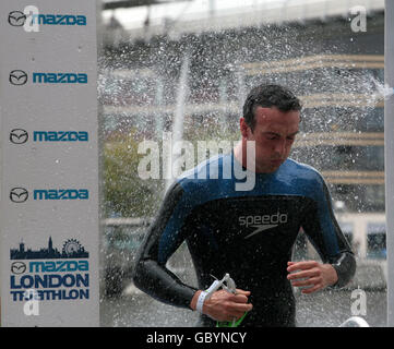 Athlétisme - Mazda London Triathlon - première journée.Un concurrent court par une douche après avoir terminé la section de natation pendant le triathlon de Mazda London, Londres. Banque D'Images