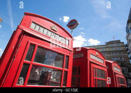 Téléphone rouge dans les cases d'une ligne à l'extérieur de la gare de Charing Cross, Londres, Angleterre, Royaume-Uni Banque D'Images