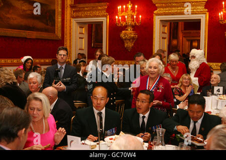 Dame Vera Lynn (au centre-droit) assiste à la fête de Noël de l'Association non oubliée, organisée par la princesse Royale. Des blessés en service et des ex-militaires, hommes et femmes handicapés, ont également assisté à la fête au Palais St James's, dans le centre de Londres. Banque D'Images