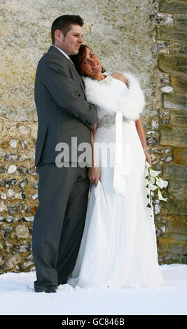 Récemment mariés Jonathan et Karen Lee posent pour des photographies alors qu'ils quittent la vieille église dans le village perdu de Dode, Kent, après leur cérémonie de mariage. Banque D'Images