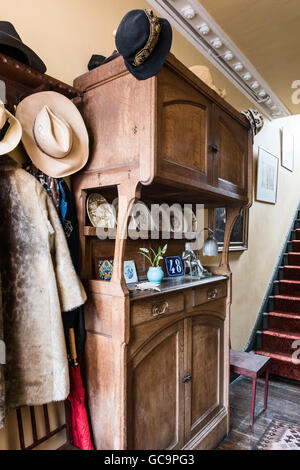 Cabinet en bois ancien avec des chapeaux et des manteaux à Nottinghill couloir, Londres, Royaume-Uni Banque D'Images