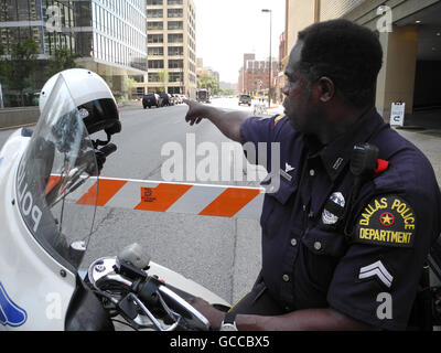 Dallas, États-Unis. 8 juillet, 2016. Un policier sur une moto à l'un des points des scènes de crime dans le centre de Dallas, États-Unis, 8 juillet 2016. Probablement par la haine envers les blancs, au moins cinq policiers ont été abattus dans la ville de Dallas nous lors d'une marche de protestation contre la violence policière. Au moins sept policiers et deux civils ont été blessés selon une déclaration faite par le Texanian les autorités locales de la ville le vendredi. Photo : Johannes Schmitt-Tegge/dpa/Alamy Live News Banque D'Images