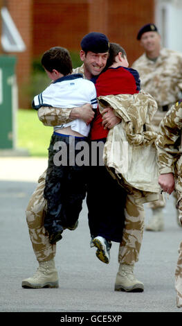 Le major Jamie Baxter de Weston-super-Mare est accueilli par ses fils Isaac, 5 ans (à gauche) et Alexander, 8 ans, comme Medics de l'Armée de terre de l'hôpital Field de 33, Royal Medical corps de retour à fort Blockhouse à Gosport, Hampshire, après une visite de l'Afghanistan. Banque D'Images