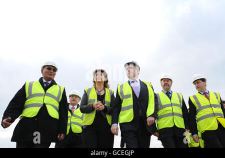 Le Premier ministre Gordon Brown (au centre) et sa femme Sarah marchent jusqu'à Converteam à Rugby, une entreprise qui fabrique des convertisseurs électriques pour les éoliennes. Banque D'Images