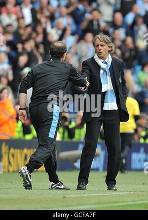 Martin O'Neill, directeur de la Villa Aston (à gauche) et Roberto Mancini, directeur de la ville de Manchester (à droite), se sont mis à serrer la main après le coup de sifflet final sur la ligne de contact. Banque D'Images