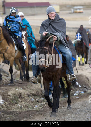 Le prince Harry, lors d'une visite à l'école de garçons de troupeau à Semongkong, au Lesotho, fait un cheval à travers le village accompagné du prince Seeiso du Lesotho. Banque D'Images