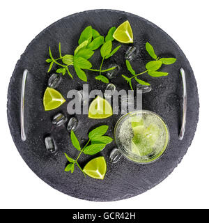 Mojito cocktail avec splash, glace, menthe verte, essence limes et tombe sur un plateau de fond en pierre d'ardoise noire est isolé, Banque D'Images