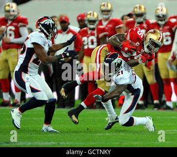 San Francisco 49ers Vernon Davis (en haut à droite) est affrontée par Denver Broncos Andre Goodman (en bas à droite) lors du match de la NFL au stade Wembley, Londres. Banque D'Images