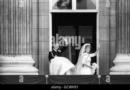 Le duc et la duchesse de York déferle devant de la foule depuis le balcon de Buckingham Palace, car ils Duke tient le train de la robe de mariage de sa mariée. Banque D'Images