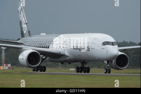 Farnborough, Hampshire, Royaume-Uni. 11 juillet 2016. Premier vol de l'Airbus A350 en vertu de l'assombrissement du ciel. Jour de l'ouverture du commerce international de Farnborough Airshow où le major international aviation et aérospatiale est signée. Le salon se déroule du 11 au 15 juillet et englobe des entreprises et de la défense civile, Aviation, l'espace, à voilure tournante et la fabrication. Le public de l'aéronautique se déroule du 16 et 17 juillet. Credit : aviationimages/Alamy Live News. Banque D'Images