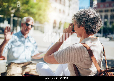 Femme parlant de son mari pendant les vacances. D'âge mûr jouissant de leurs vacances. Banque D'Images