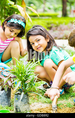 3 indiens Kids parc plantation de plantes d'amis Banque D'Images