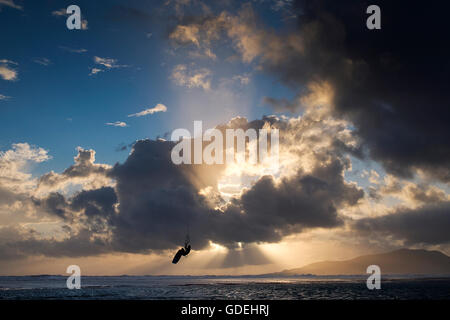 Silhouette d'un kitesurfeur mid air, la plage de Los Lances, Tarifa, Andalousie, Espagne Banque D'Images
