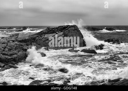 Briser les vagues sur Terre-neuve Point, St Mary's, Îles Scilly, au Royaume-Uni. Version noir et blanc Banque D'Images