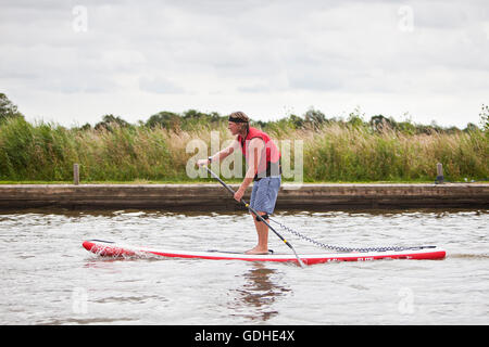 Norfolk Broads, UK. 16 juillet, 2016. La sixième Race SUP Classic Classic". Dix et cinq milles entre cours Comment Hill nature reserve et Martham passant par les ruines de l'abbaye de St Benets, Thurne Wind Mill et sous faible pont médiéval à Potter Heigham, négociation d'innombrables maison de vacances de croisière et des yachts le long de la manière. Originaire de New York comme un sport, le stand up paddle boarding est un des nouveaux sports d'eau et les Broads Classic, organisé par bateaux Martham, attire des coureurs expérimentés et novices de partout dans le pays. Credit : Adrian Buck/Alamy Live News Banque D'Images