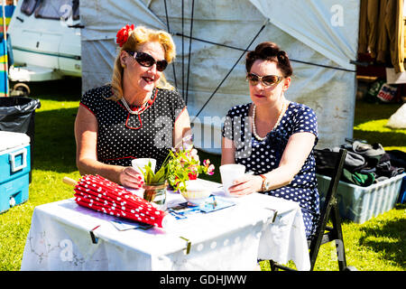 Thé anglais à l'extérieur de 2 femmes de boire du thé portant polker dot robes robe 1940 robe traditionnelle style Crédit : vêtements Tommy (Louth)/Alamy Live News Banque D'Images