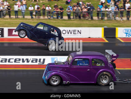 Dragstalgia événement à Santa Pod. Cooper tapis roulant son Outlaw Anglia face visible et Mark Bracking tirant un wheelie loin côté. Banque D'Images