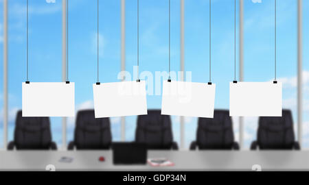 Quatre affiches vierges hanging on a rope in modern office Banque D'Images