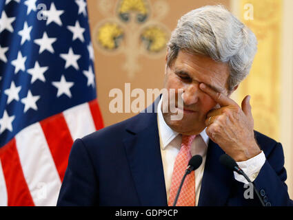 Le secrétaire d'Etat américain John Kerry essuie son œil au cours d'une conférence de presse avec le secrétaire des Affaires étrangères Boris Johnson (invisible) du ministère des Affaires étrangères à Londres. Banque D'Images