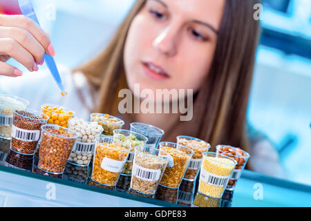 Fille dans le laboratoire de tests de qualité alimentaire de céréales légumineuses Banque D'Images
