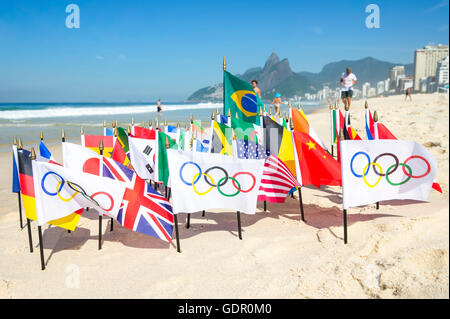 RIO DE JANEIRO - Mars 20, 2015 : drapeaux olympiques volent ensemble avec un tableau du Brésil et les drapeaux sur la plage d'Ipanema. Banque D'Images