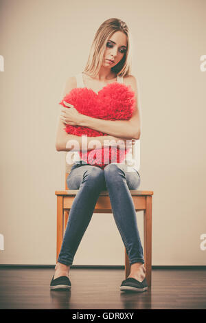 Broken Heart Love concept. Triste Malheureux woman hugging coeur rouge Banque D'Images