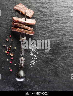 Faux-filet de boeuf aux épices sur le plateau en bois Banque D'Images