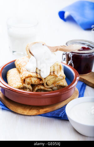 Rouleaux de crêpes faites maison avec avec avec du fromage cottage le remplissage de crème et de confiture de Banque D'Images