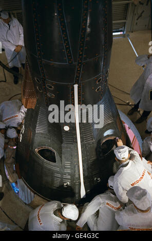 Les techniciens de la McDonnell Aircraft Corporation, qui a été responsable de la production de la capsule Gemini, de faire des inspections pour l'engin spatial Gemini III. La photo est prise dans la chambre blanche, un environnement stérile où le satellite a été préparé pour lancer, au sommet du lanceur Titan au pad 19 au Centre spatial Kennedy. Gus Grissom et John Young allions rouler l'engin spatial en orbite pour la première mission Gemini sur cinq heures de voyage dans l'espace le 23 mars 1965. Image #  : S65-21090 Date : 23 Mars 1965 Banque D'Images