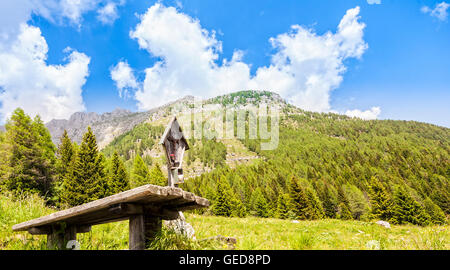 Paysage de montagne avec une table et des bancs pour le repos et le crucifié. Alpes Juliennes Le Frioul, Italie Banque D'Images