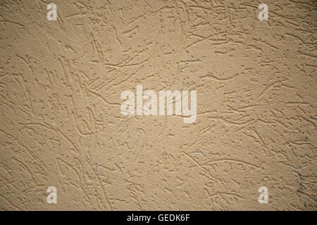 Rugueux, texturé mur en stuc jaune Banque D'Images