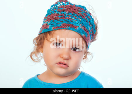 Portrait de jolie petite fille à la caméra à l'ennuyer avec look.fond blanc.isolés. Banque D'Images