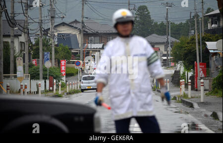 Tokyo, Japon. 26 juillet, 2016. Un agent de police japonaise peut être vu diriger la circulation près de Tsukui Yamayuri-en centre de soins pour personnes handicapées dans la ville de Sagamihara, préfecture de Kanagawa au Japon. Plus tôt ce jour 26 ans, Satoshi Uematsu, un résident local et ex-employé du centre de soins utilisés plusieurs couteaux à tué 19 personnes et blessé 25 autres. Selon un journal local, Uematsu a renoncé à lui-même à la police autour de 15 minutes après le personnel du centre de soins de l'alerter. Credit : ZUMA Press, Inc./Alamy Live News Banque D'Images