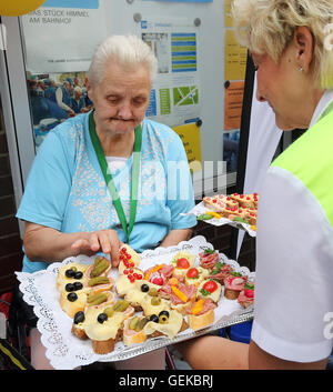 Berlin, Allemagne. 27 juillet, 2016. Avec un employé du service de sécurité de la BVG les mains hors des sandwichs à gauche plus de la visite du ministre des Affaires étrangères pour les sans-abri à l'extérieur de la Mission évangélique de la gare Zoologischer Garten de Berlin, Allemagne, 27 juillet 2016. Photo : WOLFGANG KUMM/dpa/Alamy Live News Banque D'Images