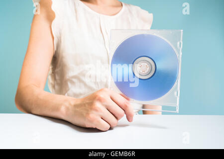 Businesswoman holding DVD-ROM Banque D'Images