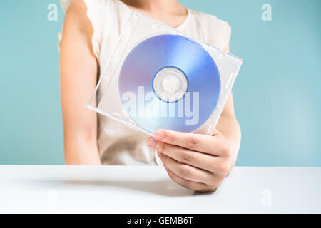 Businesswoman holding DVD-ROM Banque D'Images