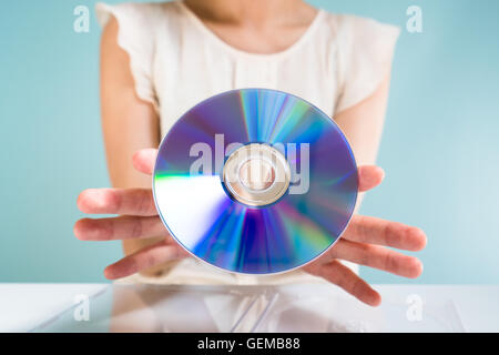 Businesswoman holding DVD-ROM Banque D'Images